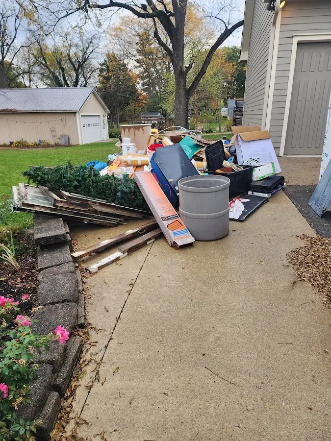 Dumpster being loaded with debris for Estate Cleanout Dumpster Rental in Chillicothe